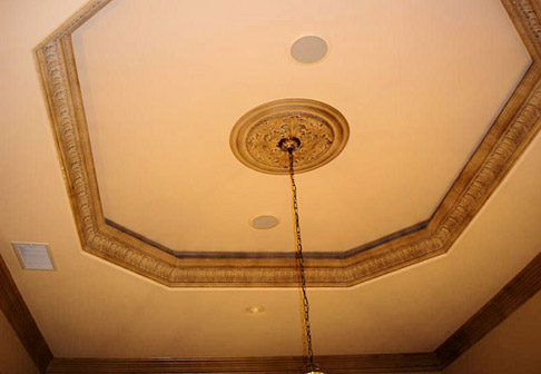 Newly painted yellow wall above chandelier