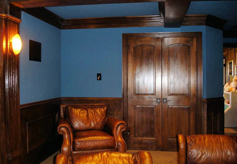 Room with dark blue walls and wood antique furniture