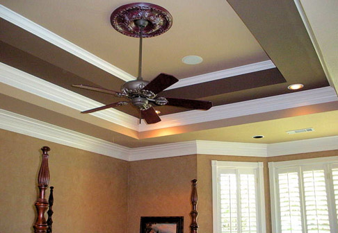 Ceiling fan in room with yellow walls