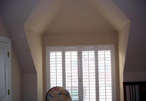 Window surrounded by pale yellow walls