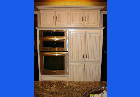 Freshly painted white cabinets in kitchen