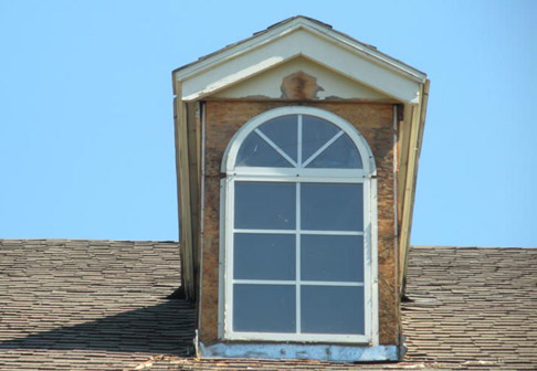 Attic window with old peeling paint