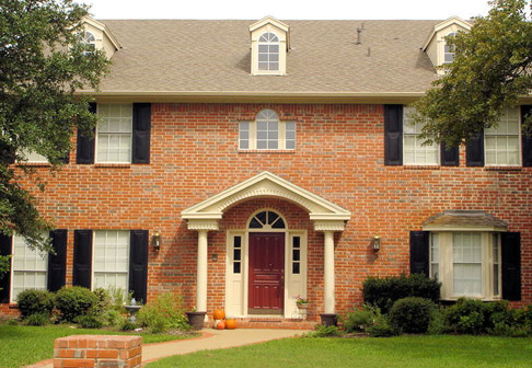 Exterior of freshly painted red brick house