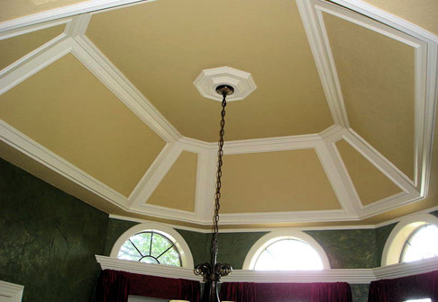 Yellow ceiling above chandelier