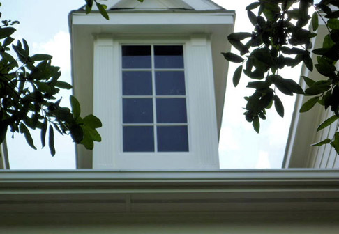 Exterior of attic window with fresh white paint