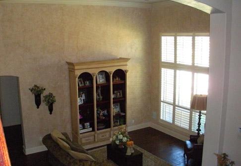 Living room with white bookshelf and yellow walls