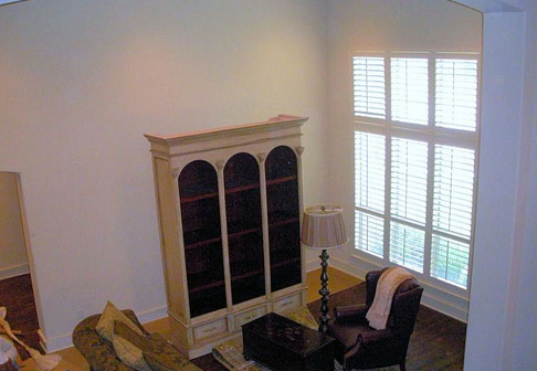 Living room with white bookshelf and white walls