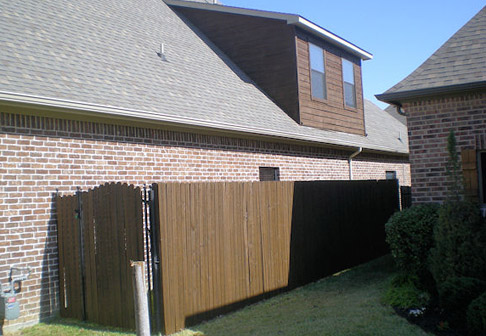 Fence freshly painted dark brown