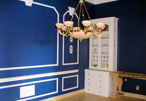 Room with chandelier and dark blue walls