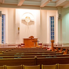 the interior of a church with wooden pews