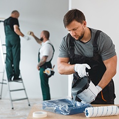 a team of professional painters working diligently  