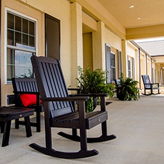 a rocking chair outside a senior living facility