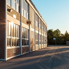 the exterior of a school and schoolyard 