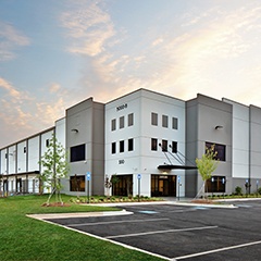 a modern industrial warehouse during the sunrise