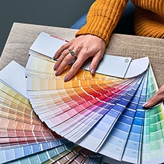 a business owner examining paint color samples