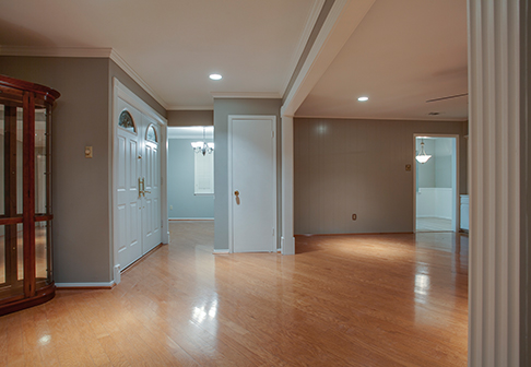 Empty room with wood floors and pale gray walls