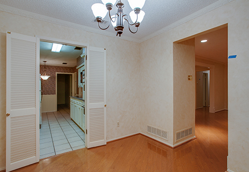 Corner of room with two doorways with pale yellow walls