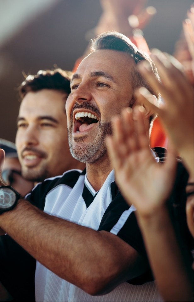 man cheering at sports game