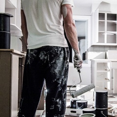 man painting cabinets