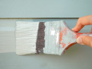 green paintbrush on an exterior wall 