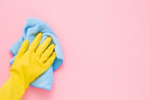 person dusting their painted walls before they clean them