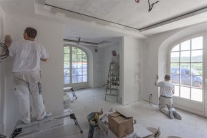 a painting team painting the inside of a house