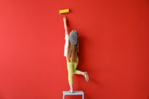 girl painting a colorful wall