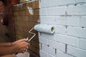 person painting brick