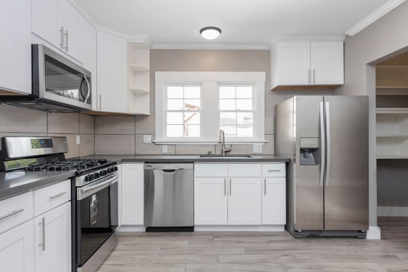white kitchen with stainless steel appliances