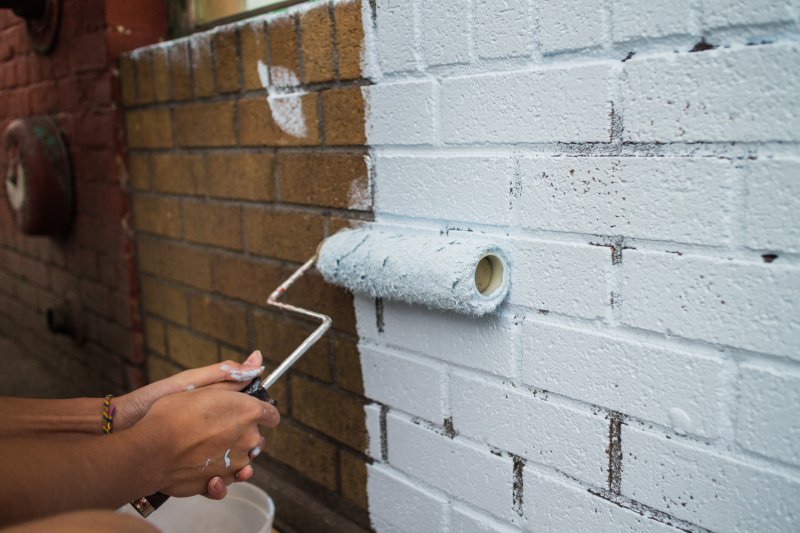 closeup of person brick painting 