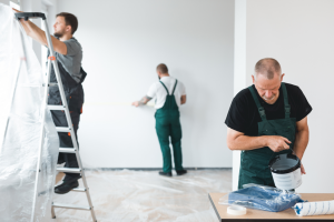 a team of painters painting a home