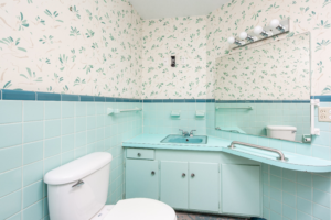 a bathroom with outdated wallpaper