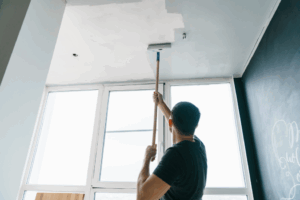 a person painting an interior ceiling 