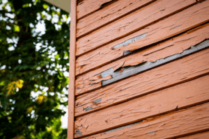 a close-up of an exterior wall with peeling paint