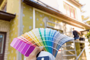 a person using a color wheel during an exterior painting project