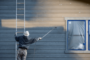 a man painting a commercial building