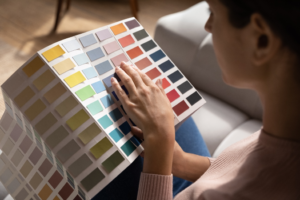a person looking at paint samples